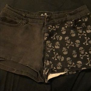 Faded black jean shorts with skulls